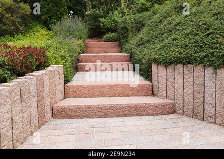 Cortile anteriore ordinato e ordinato con gradini a blocco solido, ghiaia decorativa e piantatura Foto Stock