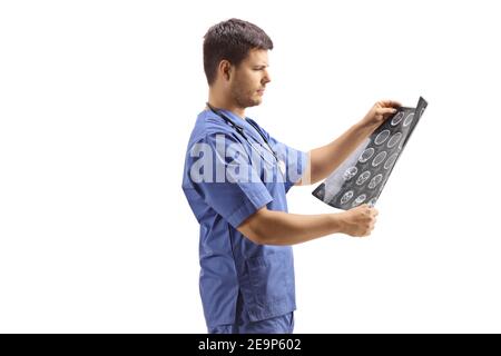 Medico maschile in un'uniforme blu che guarda l'immagine radiografica isolato su sfondo bianco Foto Stock