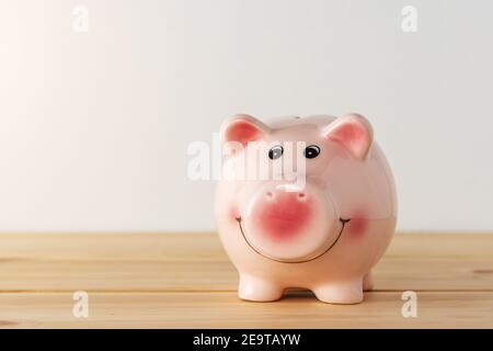Banco di porcellini su un tavolo di legno. Concetto di risparmio. Foto Stock