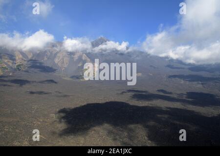 Nuvole basse e ombre scure sulla Bove Valley, sullo sfondo Sud-Est Etna vulcanico cono, Sicilia Foto Stock