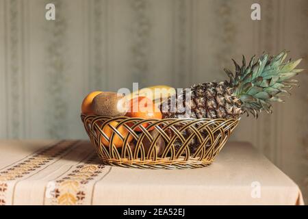 Cesto di frutta con frutta tropicale sul tavolo Foto Stock