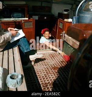 Donna pulizia a bordo barca Asperida Foto Stock