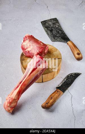 Vista dall'alto del dente fresco di cervo crudo con spezie e. erba su sfondo concreto Foto Stock