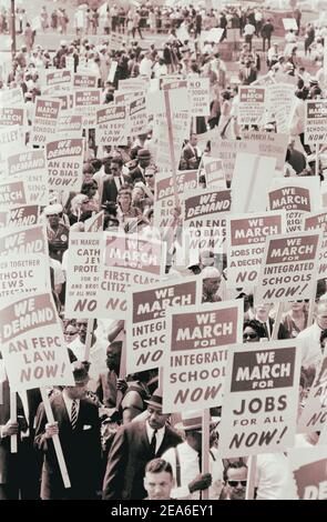 I manifestanti marciano in strada con cartelli durante la marcia a Washington, USA. 28 agosto 1963 Foto Stock