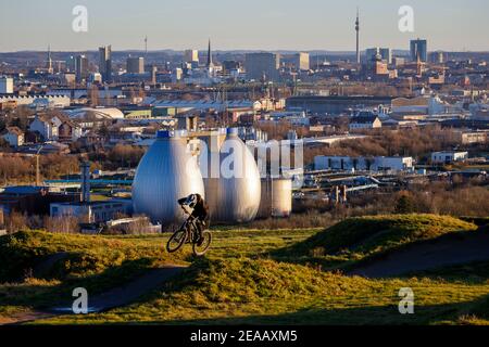 Dortmund, zona Ruhr, Renania Settentrionale-Vestfalia, Germania - panorama della città Dortmund, mountain bike, mountain bike arena sul Deusenberg di fronte allo skyline del centro di Dortmund, sul retro della torre della TV Florian e Dortmund, Di fronte alle torri di digestione dell'impianto di trattamento delle acque reflue di Emscher a Dortmund Deusen, l'impianto di trattamento delle acque reflue sta ora ricevendo una quarta fase che libera anche le acque reflue trattate dai residui di farmaci. Foto Stock