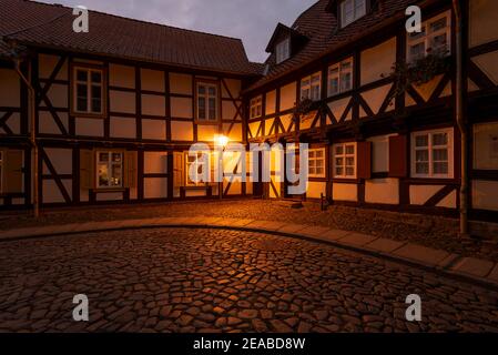 Germania, Sassonia-Anhalt, Wernigerode, illuminazione di strade storiche in un vicolo con case a graticcio Foto Stock