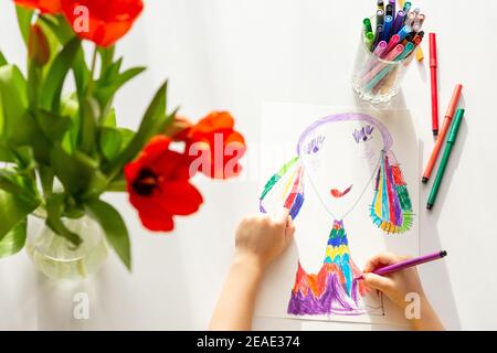 Vista dall'alto . Primo piano delle mani dei bambini disegnano un ritratto di mamma Foto Stock