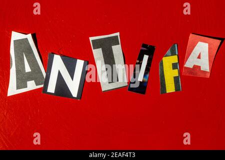 TheWord 'ANTIFA' usando le lettere di carta ritagliate nella nota di riscatto Effetto tipografico su sfondo rosso Foto Stock