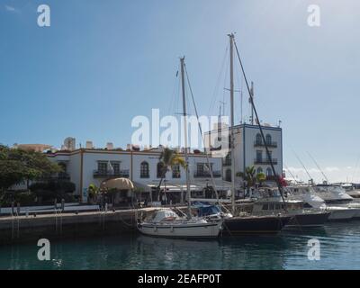 Puerto de Mogan, Gran Canaria, Isole Canarie, Spagna 18 dicembre 2020: Marina, navi ed edifici colorati a passeggiata pedonale di piccola pesca Foto Stock