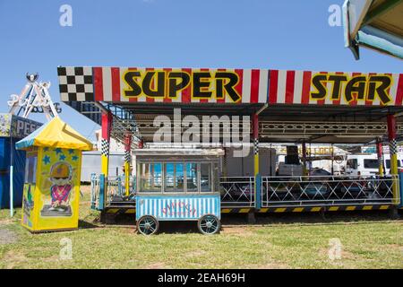 Ibitinga, SP, Brasile - 02 07 2021: Un carretto di popcorn vintage di fronte a un Bumper Cars Ride in un parco divertimenti Foto Stock