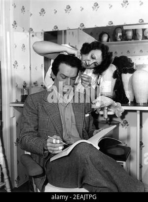 DOUGLAS FAIRBANKS Jr dietro le quinte candida avendo i suoi capelli Fissato da Studio Hairdresser durante la realizzazione DELL'ESILIO 1947 direttore MAX OPHULS produttore Douglas Fairbanks Jr Fairbanks Company / Universale - Internazionale Foto Stock