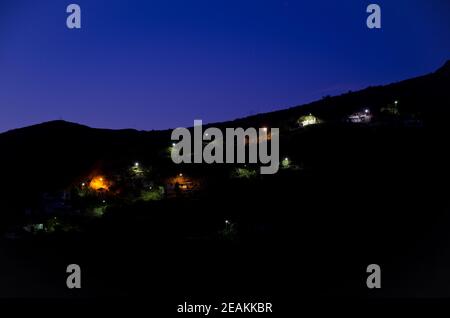 Luci nel villaggio di Ronda al tramonto. Foto Stock