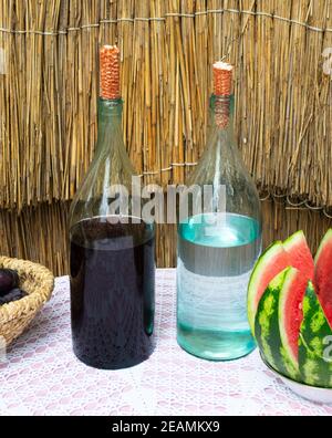 Il numero di bottiglie di vino e moonshine sul tavolo Foto Stock