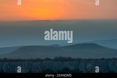 Dawn nelle montagne di Crimea, luce foschia di nebbia sulle montagne e raggi del sole attraverso le nuvole. Foto Stock