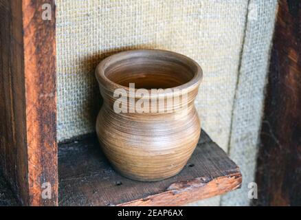 Scaffali con in piedi sui loro utensili di porcellana e terracotta. Utensili da cucina vintage Foto Stock