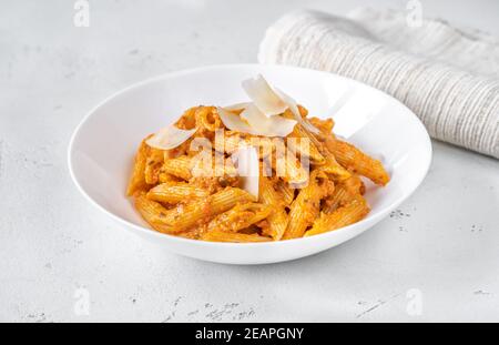 Porzione di pasta di penne con salsa al pesto d'arancia Foto Stock