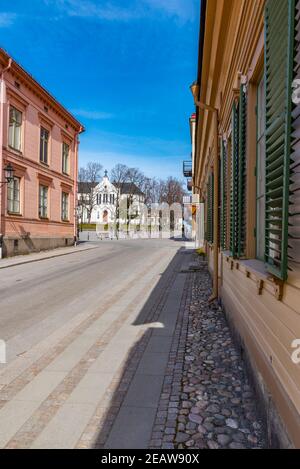 Case di legno lungo una strada stretta a Nora, Svezia Foto Stock
