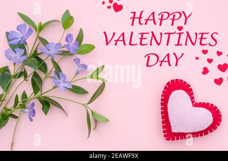 Biglietto d'auguri con l'iscrizione Happy San Valentino in un sfondo rosa con un cuore e fiori campane Foto Stock