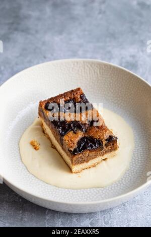 Torta di prugna secca e noce con crema alla vaniglia Foto Stock