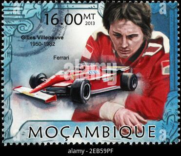 Il pilota da corsa Gilles Villeneuve e la sua Ferrari sul francobollo Foto Stock