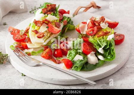 Lattuga romana condito con pomodoro pancetta parmigiano, salsa. sano cheto paleo dieta pranzo Foto Stock