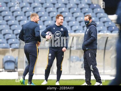 BT Murrayfield Stadium, Edinburgh.Scotland UK.12th Feb 21. Scozia sessione di allenamento Rugby Squad per la partita Guinness Six Nations vs Galles Pic mostra Scozia Finn Russell (Racing 92) & Captain Stuart Hogg (Exeter Chiefs) chattando con l'allenatore di assistenza Chris Paterson Credit: eric mcowat/Alamy Live News Foto Stock