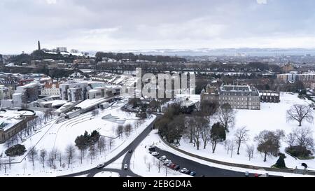 Vista invernale del Parlamento Scozzese e del Palazzo di Holyroodhouse a Holyrood nella neve, Edimburgo, Scozia, Regno Unito Foto Stock