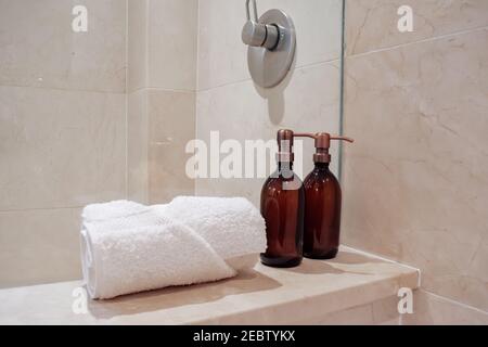 Dispenser marrone ecologico con gel doccia, sapone liquido o shampoo su uno  sgabello di legno in bagno Foto stock - Alamy