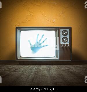 Concetto di film spaventoso horror. Mano di fantasma sullo schermo della tv vintage in casa infestata. illustrazione 3d Foto Stock