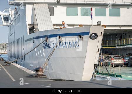 Spalato, Croazia - 15 agosto 2020: Turisti e auto a bordo di traghetto jadrolinija Liner al porto vecchio di mattina Foto Stock