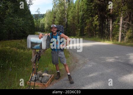 Attraverso l'escursionista Isaac a piedi il Pacific Northwest National Scenic Trail nella Yaak Valley lungo la Yaak River Road. (Foto di Randy Beacham) Foto Stock