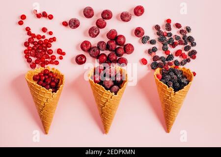 vista dall'alto delle bacche in una tazza di waffle su a. sfondo rosa Foto Stock