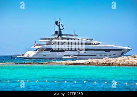 Superyacht vicino spiaggia turchese con vista sulle isole Paklenski, arcipelago di Hvar, Dalmazia regione della Croazia Foto Stock