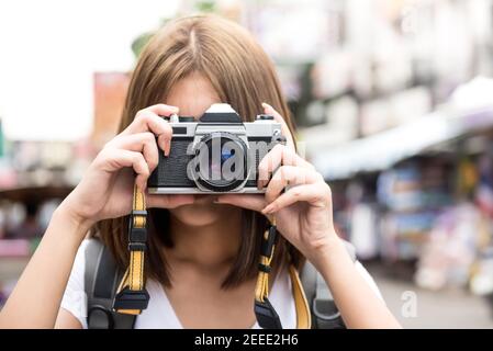 Viaggiare asiatico donna turista backpackers scattare foto a Khao san strada, Bangkok, Thailandia in vacanza Foto Stock