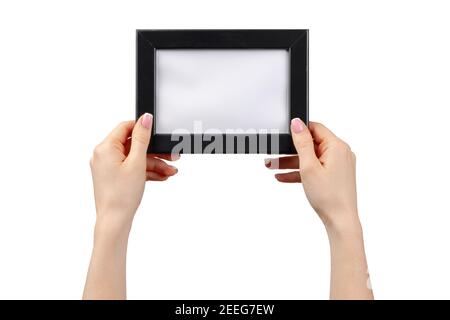 Le mani femminili tengono la cornice fotografica isolata su bianco Foto Stock