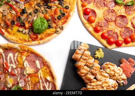 Pizza e sushi roll per menu isolati su bianco. Set combinato di panini e pizza con foglie di basilico, funghi, pomodoro, formaggio, olive, pepe, pepperoni. Foto Stock