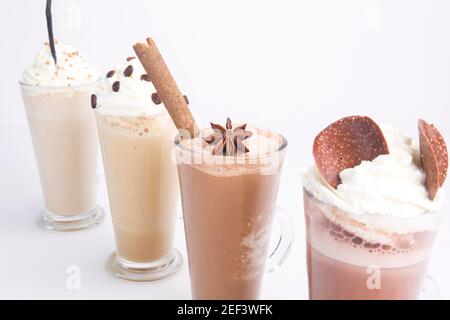 vari tipi di cioccolato e caffè con frullati di crema posizionati diagonalmente sfondo bianco Foto Stock