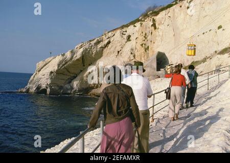 Vista posteriore di un gruppo di turisti che camminano verso una stazione della funivia, Israele Foto Stock