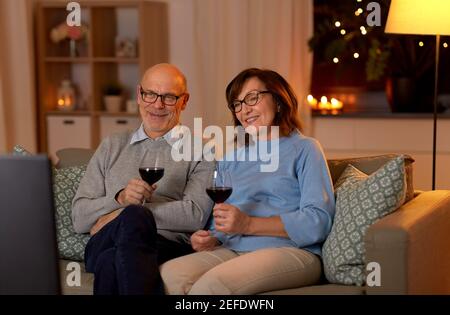 buona coppia senior bere vino rosso e guardare la tv Foto Stock