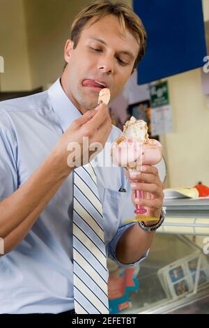 Uomo medio adulto che mangia un gelato Foto Stock