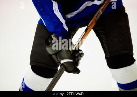 Vista in sezione intermedia di un giocatore di hockey su ghiaccio che gioca su ghiaccio hockey Foto Stock