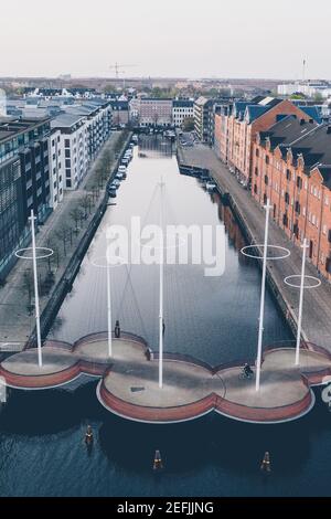 Copenaghen, Danimarca - 25 aprile 2019. Il Cirkelbroen (il Circle Bridge) è un ponte pedonale che attraversa la foce meridionale del canale di Christianshavn, nella zona di Christianshavn, nel centro di Copenaghen. Il ponte è stato progettato da Olafur Eliasson. Foto Stock