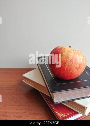 Pila di libri e mela sulla parte superiore Foto Stock