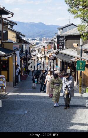 I visitatori camminano lungo Ninenzaka, o Ninen-zaka, una strada pedonale preservata per lo shopping nell'area di Higashiyama di Kyoto, Giappone Foto Stock