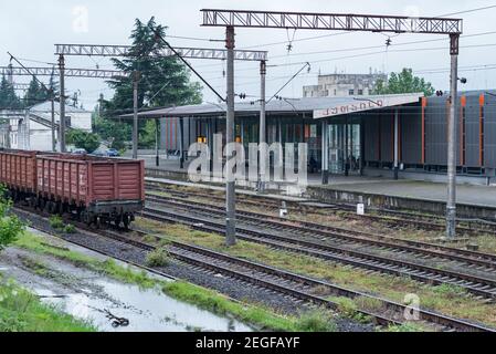 Stazione ferroviaria di Kutaisi con pochi passeggeri (irriconoscibile). È scritto "Kutaisi" sulla capanna della stazione in stile georgiano. Foto Stock