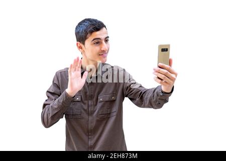 Ragazzo arabo che ha una videochiamata sul suo smartphone Foto Stock