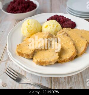 Lombo di maiale in crema e salsa di rafano con patate e insalata di barbabietole bollite. Foto Stock