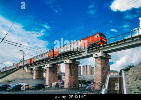 Ponte ferroviario su strada e treno suburbano a Kazan, Russia. Emissioni zero dei trasporti pubblici, concetto di ambiente protetto. Foto Stock