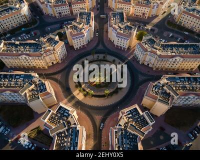 Rotonda e simmetria architettonica di International City a Dubai, Emirati Arabi Uniti. Architettura suburbana a tema country di residenze nel Foto Stock