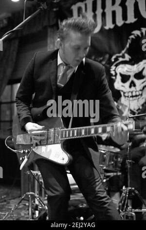 Teddy Boy suonando la chitarra elettrica durante un concerto nel pub , UK Foto Stock